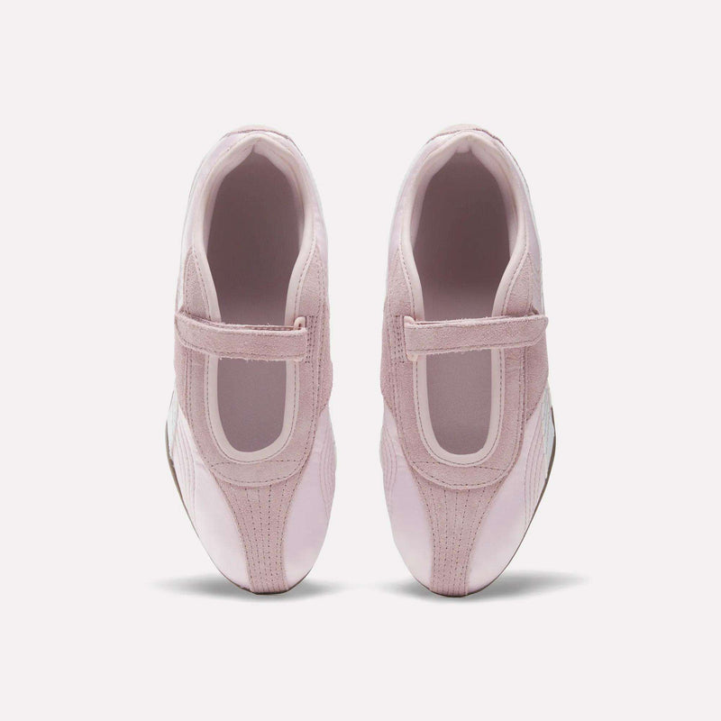A pair of Women's Ultra Lo Mary Jane Shoes by Reebok in light pink with velcro straps, styled as low-profile runners, shown from above on a plain white background.