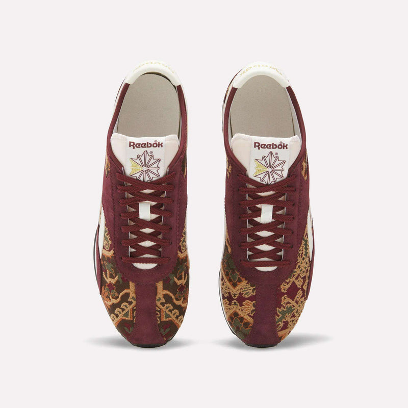 Top view of the Reebok R400 Shoes in maroon, showcasing white laces and soles, adorned with detailed gold and brown patterns on the toe and sides, a geometric motif on the tongue, and a distinct heritage-inspired style that emphasizes their premium appeal.