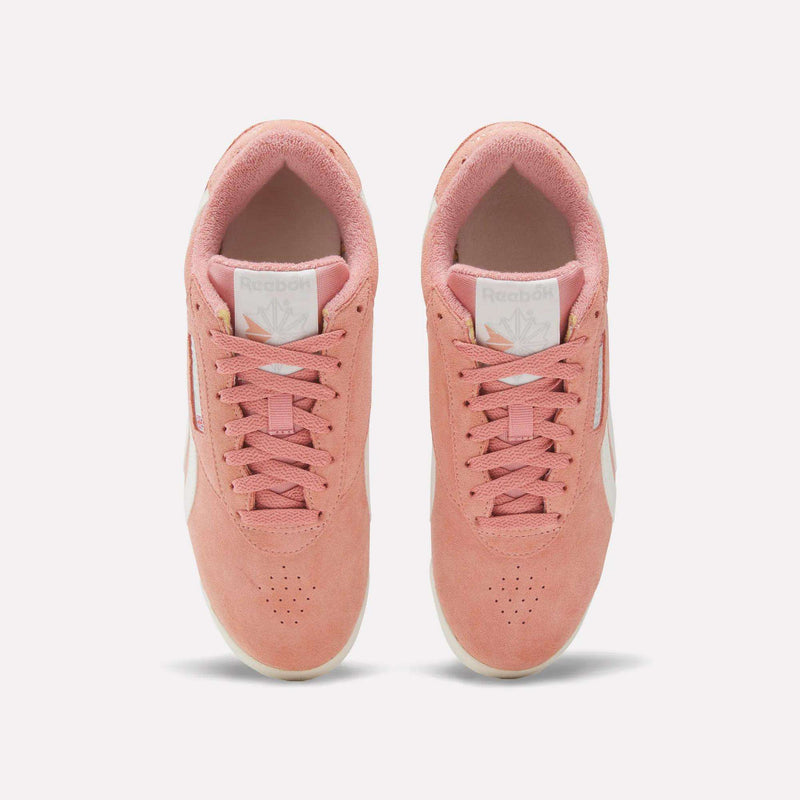The Women's Freestyle Lo Shoes by Reebok feature a pink upper with white soles and side stripes, offering classic retro sneaker style. Displayed from above on a plain white background, they're the perfect addition to any look.