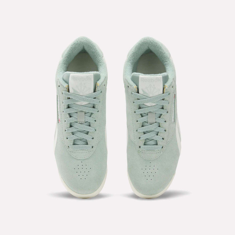 A pair of Women's Freestyle Lo Shoes by Reebok in light green suede are shown from above, displaying the tops, laces, tongues with Reebok logos, and placed side by side on a plain white background.