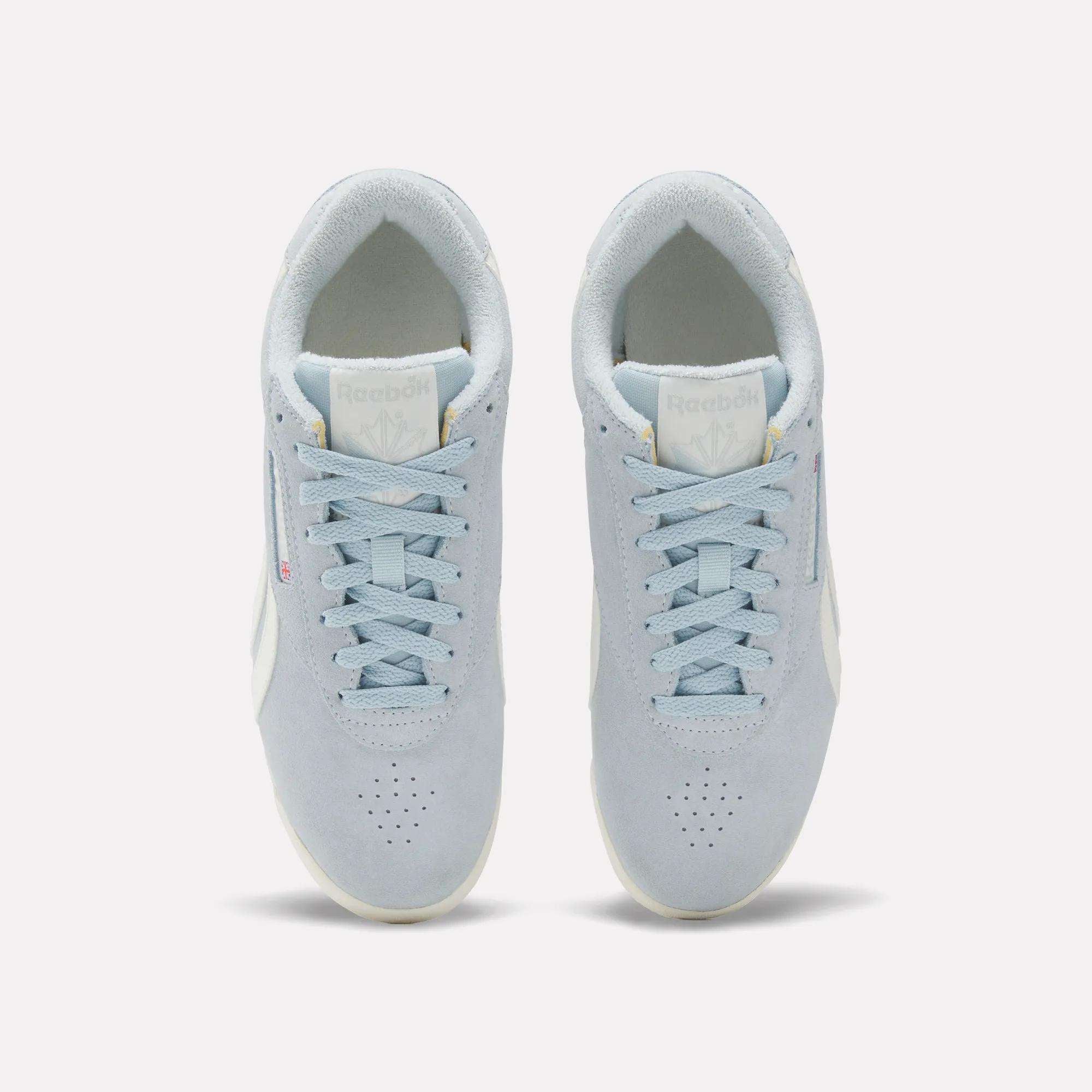 A pair of Women's Freestyle Lo Shoes by Reebok in light blue with white soles and laces, viewed from above on a plain white background.