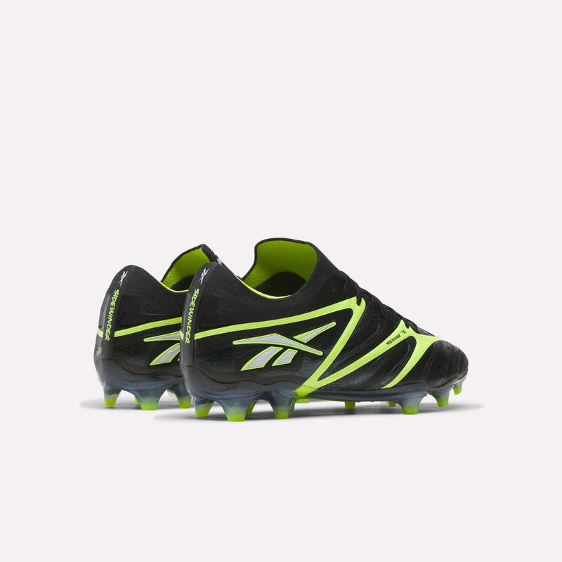 The Sidewinder 26 Elite FG Cleats by Reebok in black and neon yellow feature a white logo and are designed for firm grass, shown from the back and side on a plain white background.