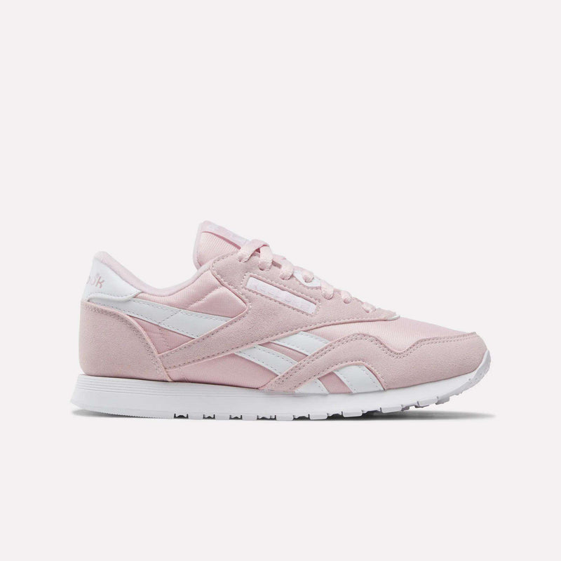 Showcased on a plain white background, the Reebok Women's Classic Nylon Shoes come in Elemental Pink with white accents and laces, featuring the iconic retro design and a white rubber sole—an ideal addition to any women's shoe collection.
