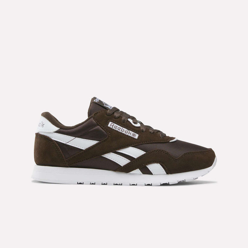 A side view of the Reebok Women’s Classic Nylon Shoes in Espresso/Espresso/White, featuring a crisp white sole and set against a simple light background, captures the vintage appeal of women’s sneakers.