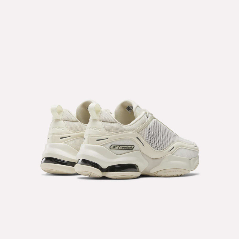 A pair of chunky, off-white Reebok DMX Series 3000 Shoes with thick soles and mesh panels, featuring DMX moving air technology for comfort, are positioned facing away on a plain white background.