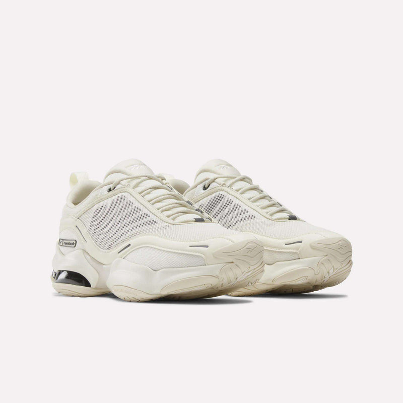 A pair of Reebok DMX Series 3000 Shoes in off-white with mesh panels, chunky textured soles, and DMX moving air technology for superior comfort, shown on a plain white background.
