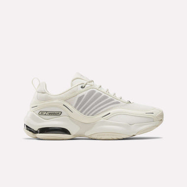 A side view of Reebok DMX Series 3000 Shoes in white, featuring mesh panels, beige accents, and a chunky sole with black and transparent details for comfort, enhanced by signature DMX moving air technology.