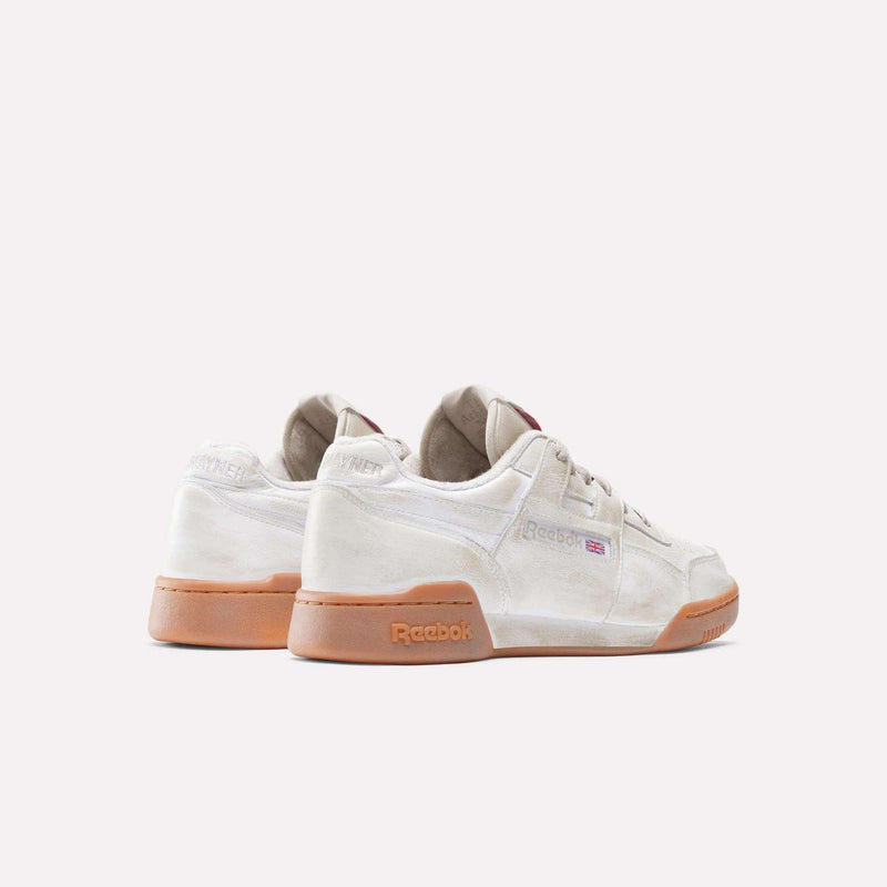 The Reebok x Hed Mayner Workout Plus OG Shoes by Reebok, featuring a white leather upper and gum soles, are displayed on a plain white background, highlighting their back and side profiles.