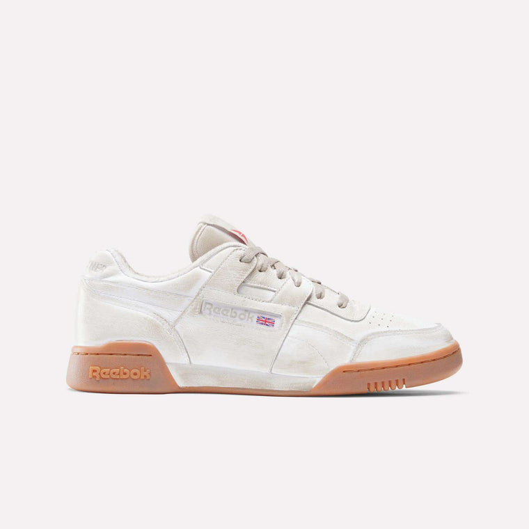The Reebok x Hed Mayner Workout Plus OG Shoes feature a beige leather upper, gum sole, tan laces, and a Reebok logo with a UK flag on the side. This fitness-inspired sneaker is shown from the side against a plain light background.