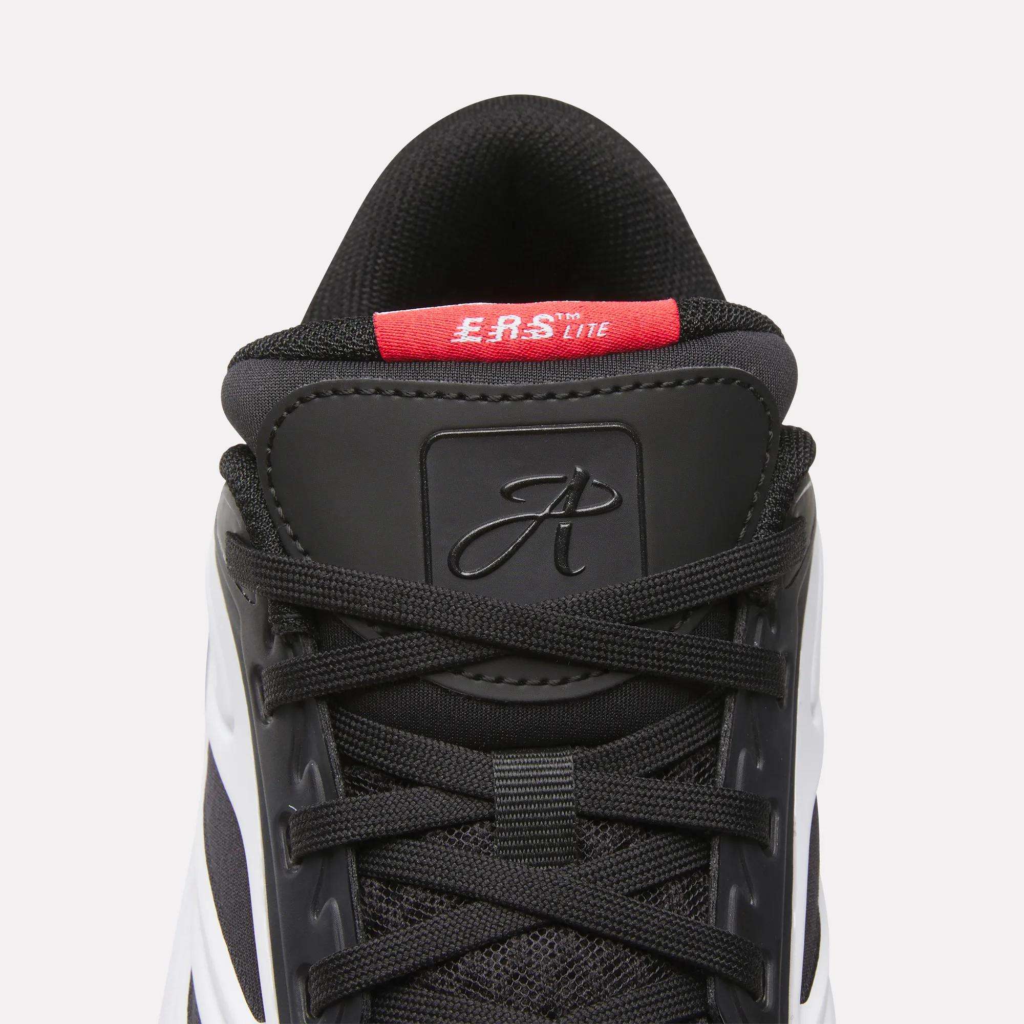 Close-up of a black Reebok Angel Reese 1 Shoes - Big Kids basketball sneaker with black laces, a red E.A.S. Lite label, stylized A on the tongue, and white and black side detailing—ideal for Angel Reese fans.