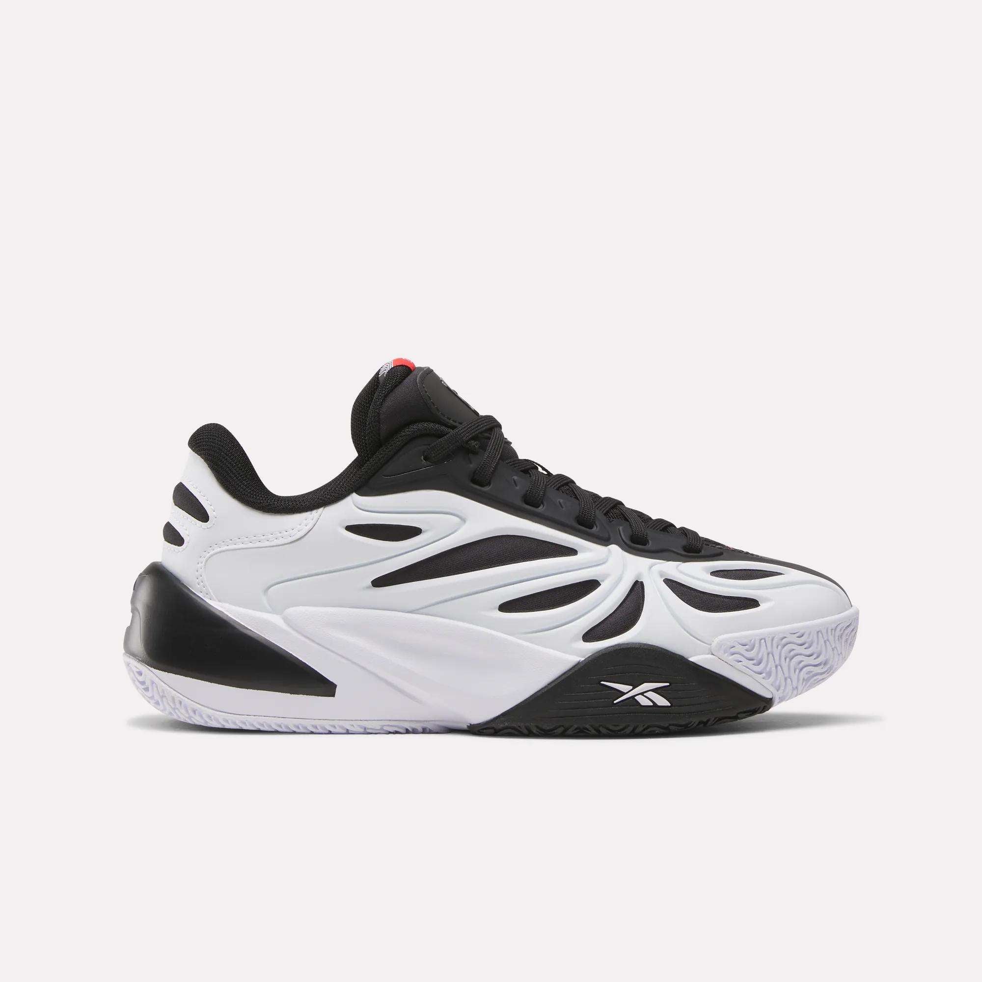 The Reebok Angel Reese 1 Shoes - Big Kids feature a stylish black and white design with a wavy side pattern, textured sole, and black laces, inspired by Angel Reese sneakers and shown in side profile on a plain white background.