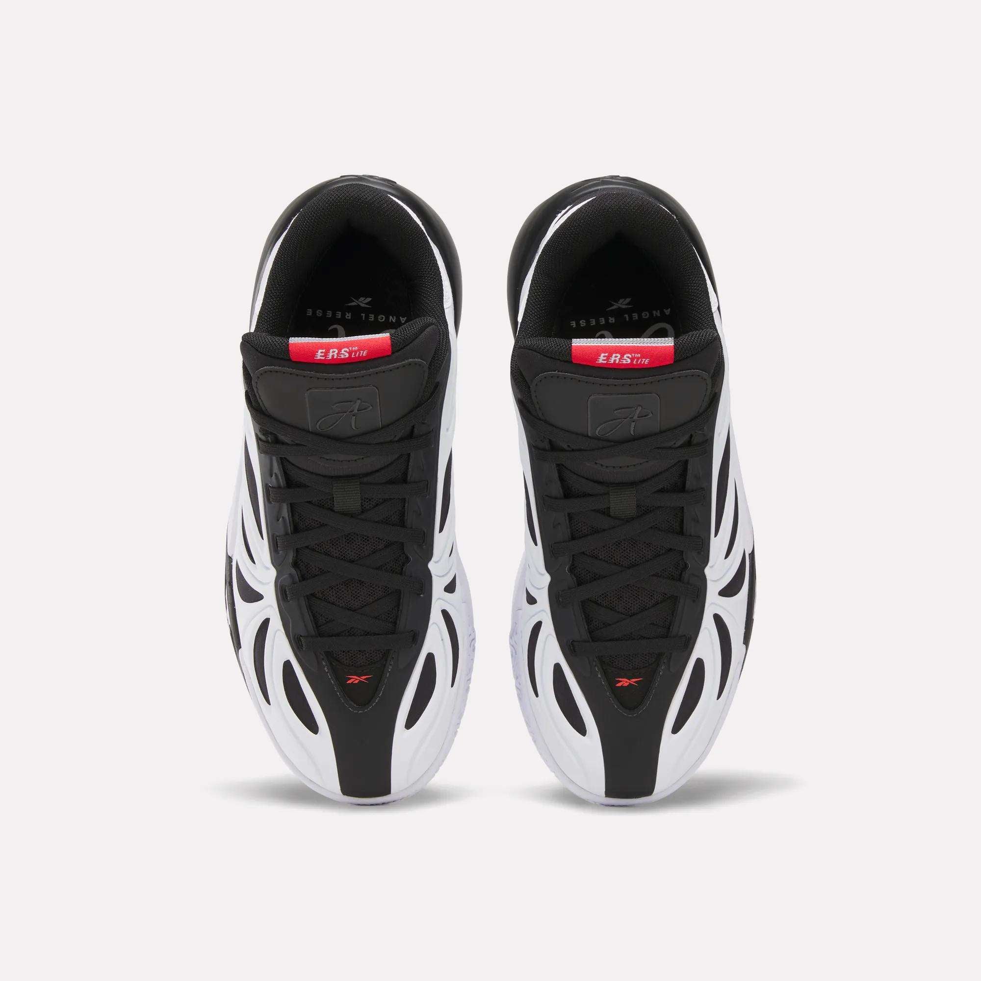 Top view of Reebok Angel Reese 1 Shoes for big kids in black and white with red and gray accents, wavy white side overlays, sleek design, and branded insoles with visible text near the heel.