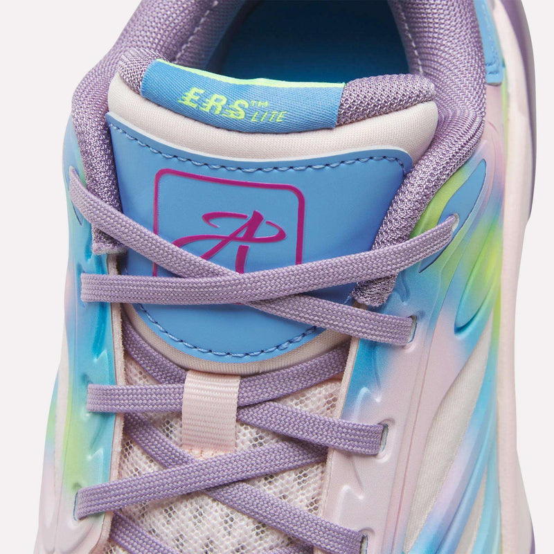 A close-up of the Reebok Angel Reese 1 Shoes - Big Kids shows pastel purple laces, a blue tongue with an ERS LITE logo, rainbow accents along the mesh upper sides, and a padded collar for comfort.