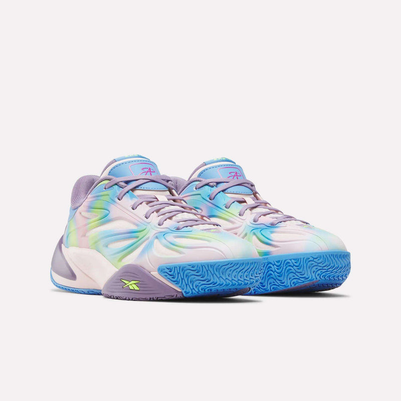 The Reebok Angel Reese 1 Shoes for big kids feature a pastel tie-dye pattern in blue, purple, and green with purple laces, blue outsoles, and the Reebok logo—perfect for young basketball fans who love bold style.