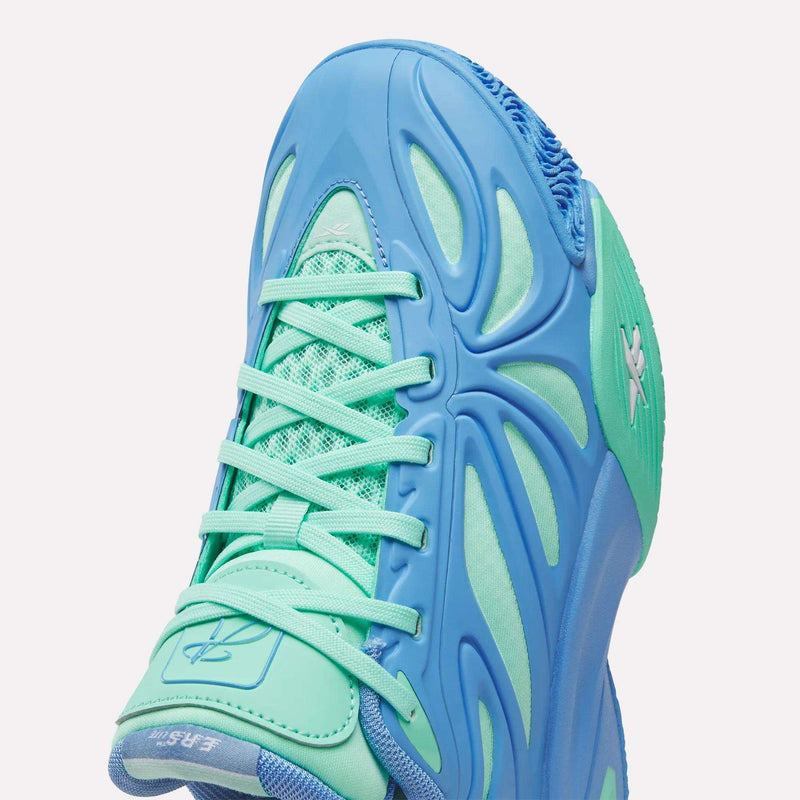 Close-up of Reebok Angel Reese 1 Shoes - Big Kids in blue and mint green, with a textured sole, abstract wavy overlays, and mint green laces—stylish basketball sneakers inspired by Angel Reese for young players.