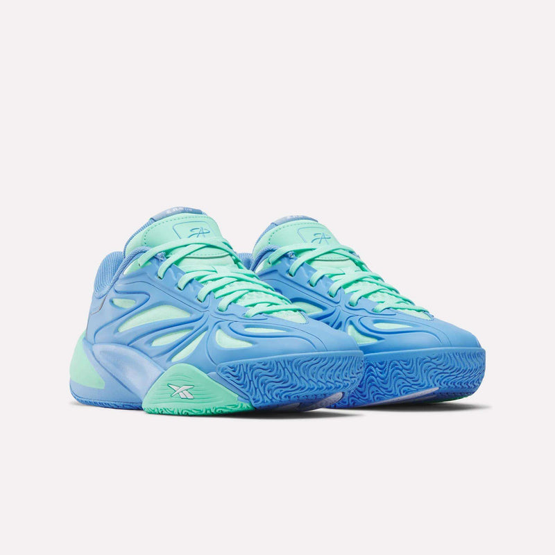 A pair of Angel Reese 1 Shoes - Big Kids by Reebok, featuring blue wavy patterns, mint green accents, textured blue soles, aqua laces, and Reebok logos on the sides and tongues, shown on a plain white background.