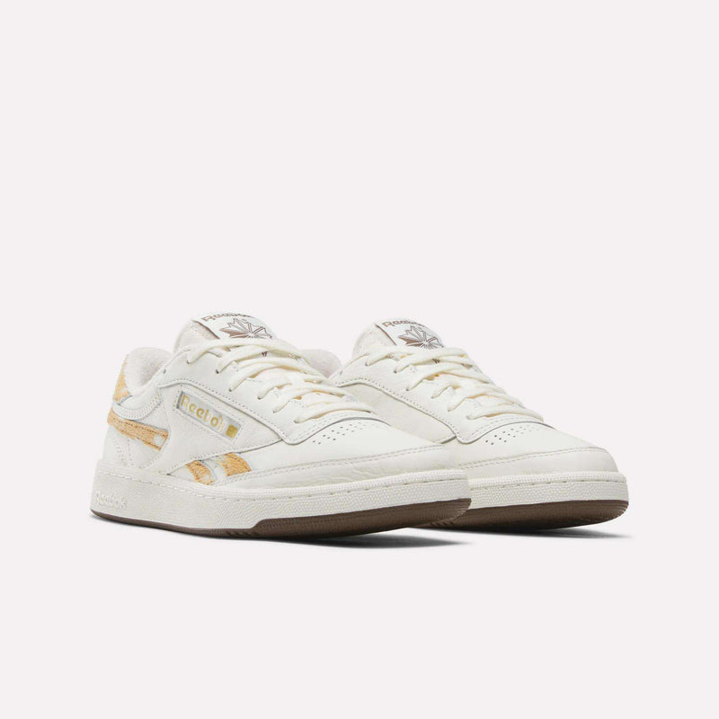 A pair of Reebok Club C Revenge Vintage Shoes in off-white, featuring a premium leather upper with tan accents, gold Reebok branding, and gum soles, displayed against a plain white background.