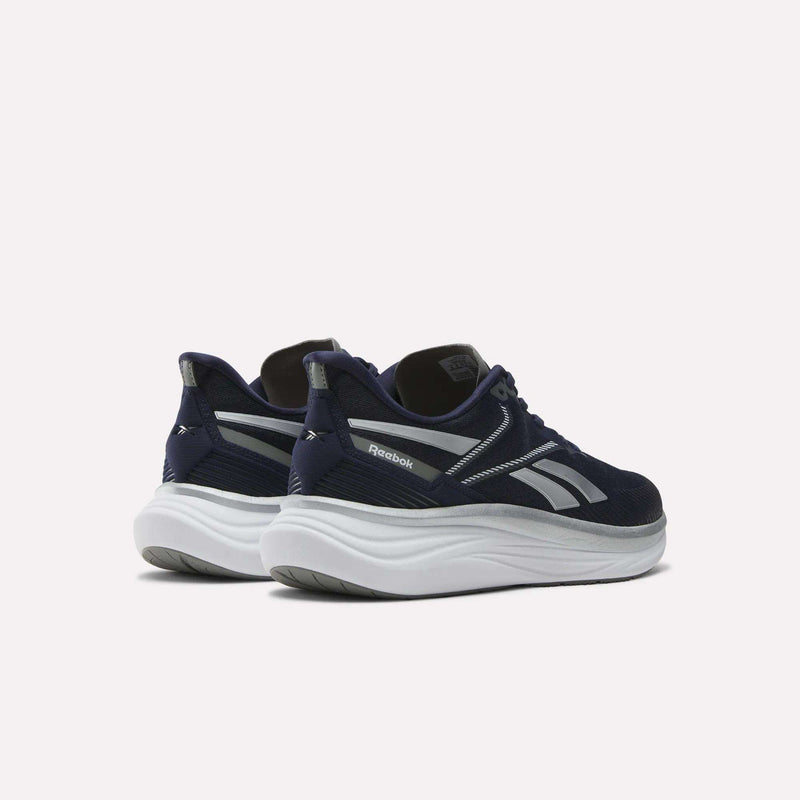 The Reebok Men's Viva Speed Shoes in navy blue with white soles and silver accents feature extra cushioning, shown on a light background at an angle to highlight side and back details.