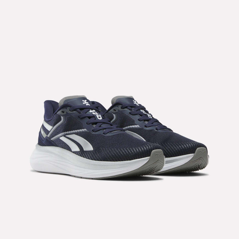 The Men's Viva Speed Shoes by Reebok are navy blue sneakers with white soles and accents, featuring the logo on the sides. These athletic shoes offer extra cushioning for comfort and are shown against a plain white background.