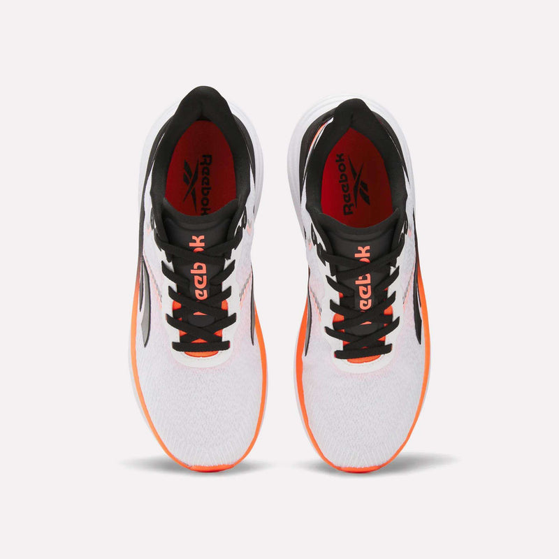 The Reebok Men's Viva Speed Shoes in white feature black laces, black details, and orange accents on the sole. Designed for breathability and extra comfort on every run. Shown from above against a plain white background.