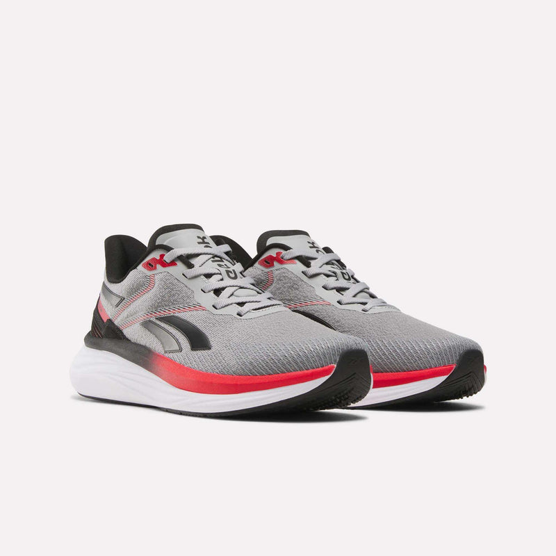 The Reebok Men's Viva Speed Shoes are gray athletic runners with black and red accents, a breathable mesh upper, cushioned white midsoles, and black outsoles, displayed on a plain white background.