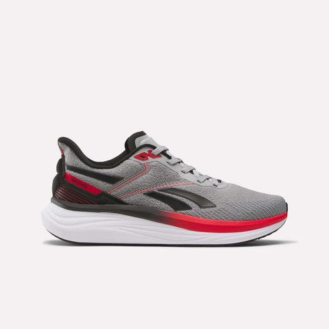 The Reebok Men's Viva Speed Shoes feature a gray mesh upper for breathability, black and red accents, a white cushioned sole, lace-up closure, and display the black Reebok logo against a plain white background.