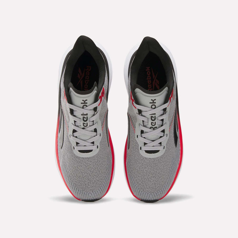 A top view of Reebok Men's Viva Speed Shoes in gray with a mesh upper, white soles, black accents, and red side details, displayed side by side on a plain white background.