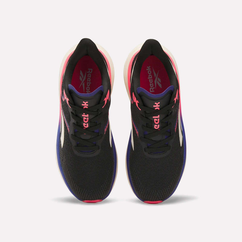 Top view of Reebok Women's Viva Speed Shoes in black with pink laces, white soles, blue accents, and Reebok logos on the insoles and tongues. These breathable shoes are displayed against a plain white background.