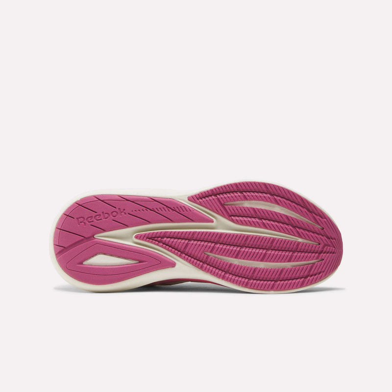 The image shows the outsole of the Reebok Women's Viva Speed Shoes, with a pink and white design, textured grooves for traction, cushioned comfort, and the Reebok logo embossed near the heel.