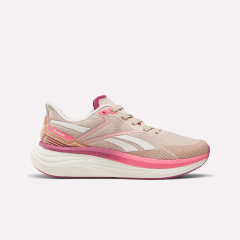 The Reebok Women's Viva Speed Shoes are light pink running shoes with white and hot pink accents, a cushioned white sole with a thick pink midsole, and the Reebok logo on the side, shown against a plain light background.
