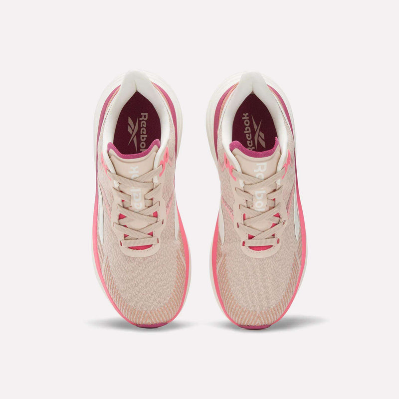 The Reebok Women's Viva Speed Shoes are light pink with white soles and laces, viewed from above, and feature soft pink accents around the midsole and heel.