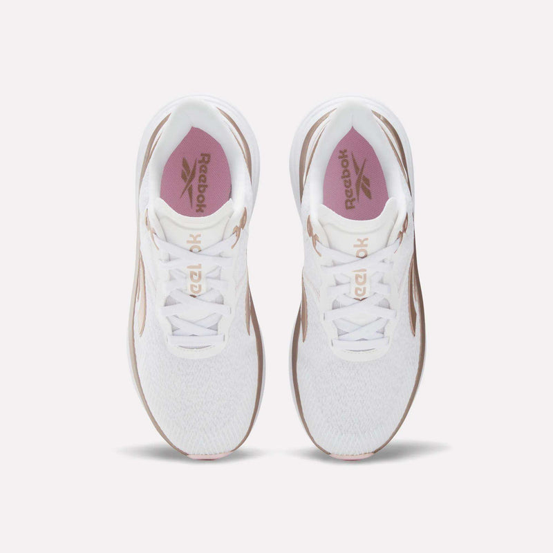 Top view of a pair of Reebok Women's Viva Speed Shoes in white with pink insoles and brown accents, extra cushioning, placed side by side on a light background.