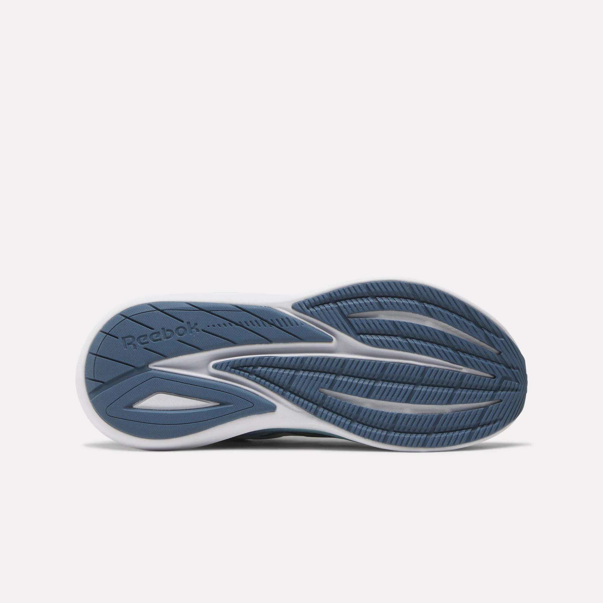 The image displays the sole of Reebok Women's Viva Speed Shoes with a blue and white design, textured and smooth patterns for traction, flexibility, added cushioning, and the Reebok logo on the left side.