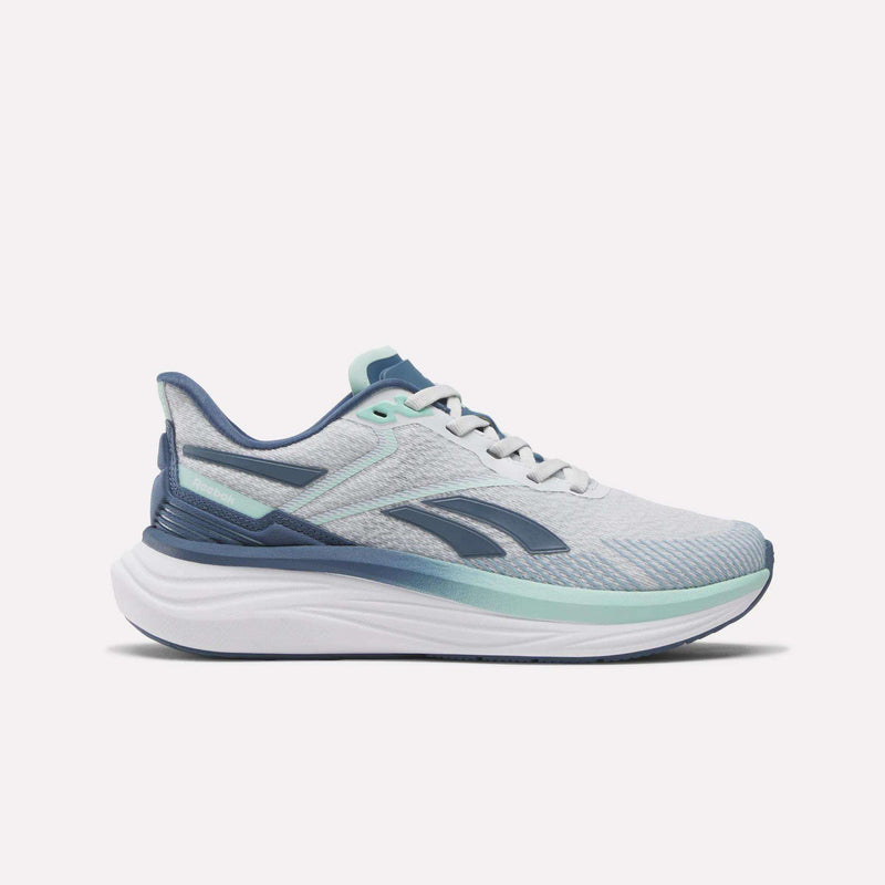 The Reebok Women's Viva Speed Shoes feature light gray and blue uppers with a white sole, dark blue accents, and mint green details. Shown side view on a white background, these breathable shoes provide comfort and style for athletic activities.