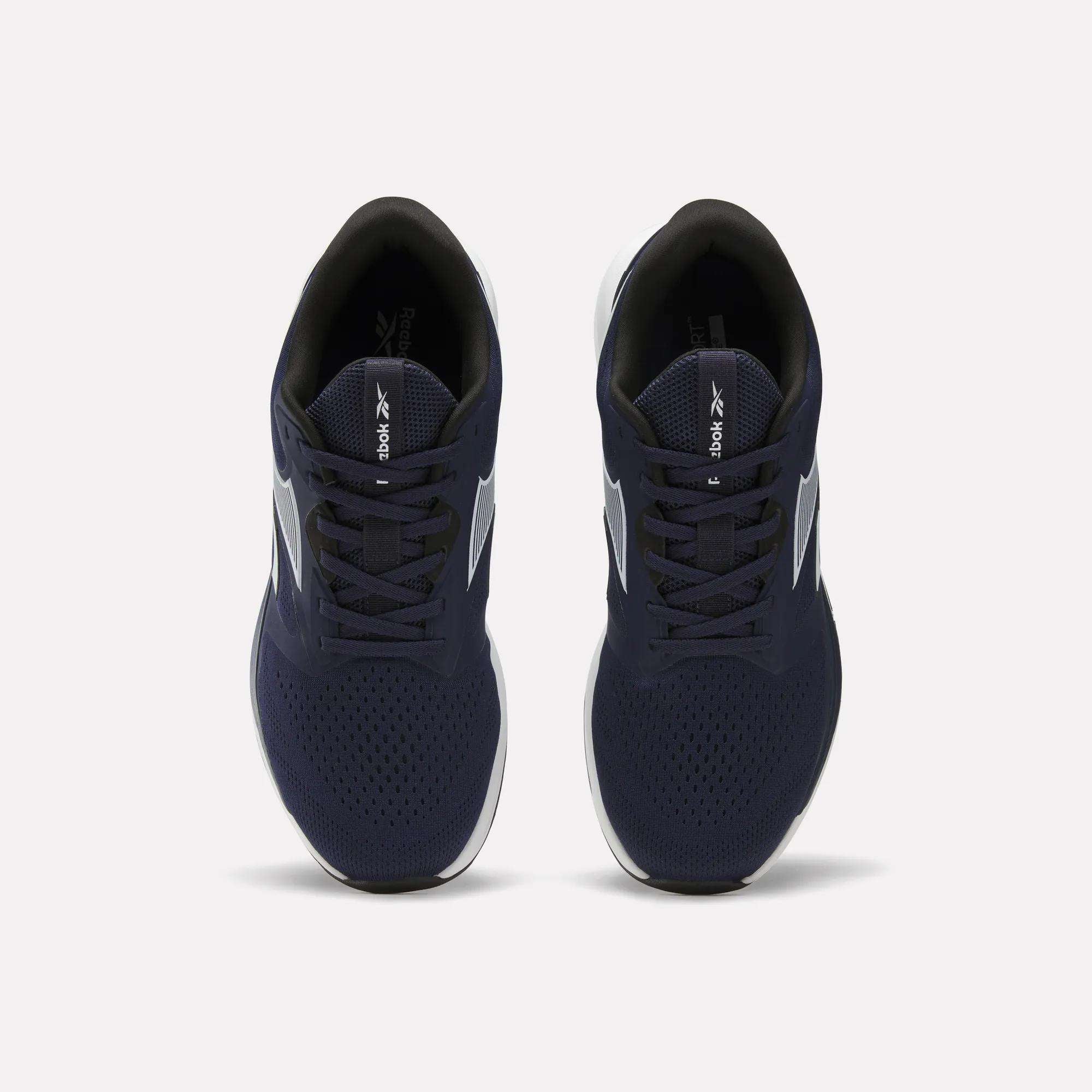Top view of Reebok Men's Nanoflex Trainer 2 Shoes featuring navy blue uppers, white soles, and black interiors, displayed side by side on a plain white background.