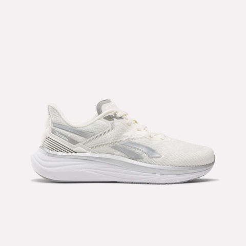 The Reebok Men's Viva Speed Shoes feature a white mesh upper for breathability, subtle gray Reebok logo, white laces, and a thick cushioned sculpted sole—shown in side profile on a white background.