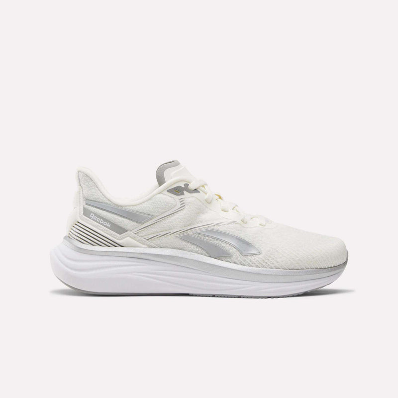 The Reebok Men's Viva Speed Shoes feature a white mesh upper for breathability, subtle gray Reebok logo, white laces, and a thick cushioned sculpted sole—shown in side profile on a white background.