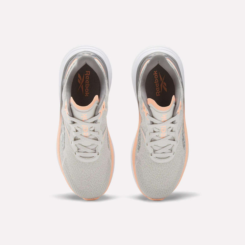 A top view of Reebok Women's Viva Speed Shoes in light gray with peach accents, featuring extra cushioning, shown on a plain white background.