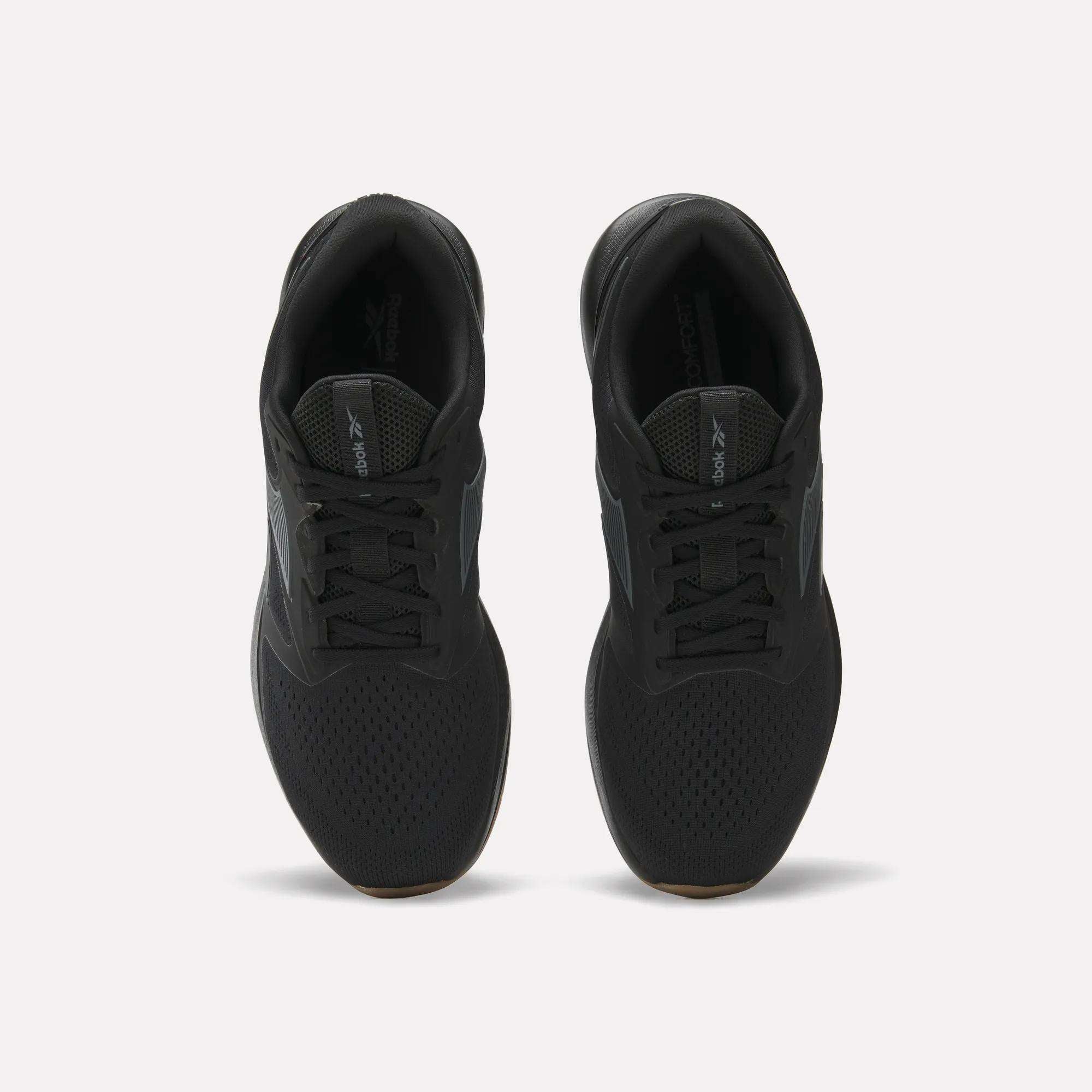 A pair of black Reebok Men's Nanoflex Trainer 2 Shoes viewed from above on a white background, featuring black laces, mesh uppers, and subtle Reebok branding on the tongue and side.