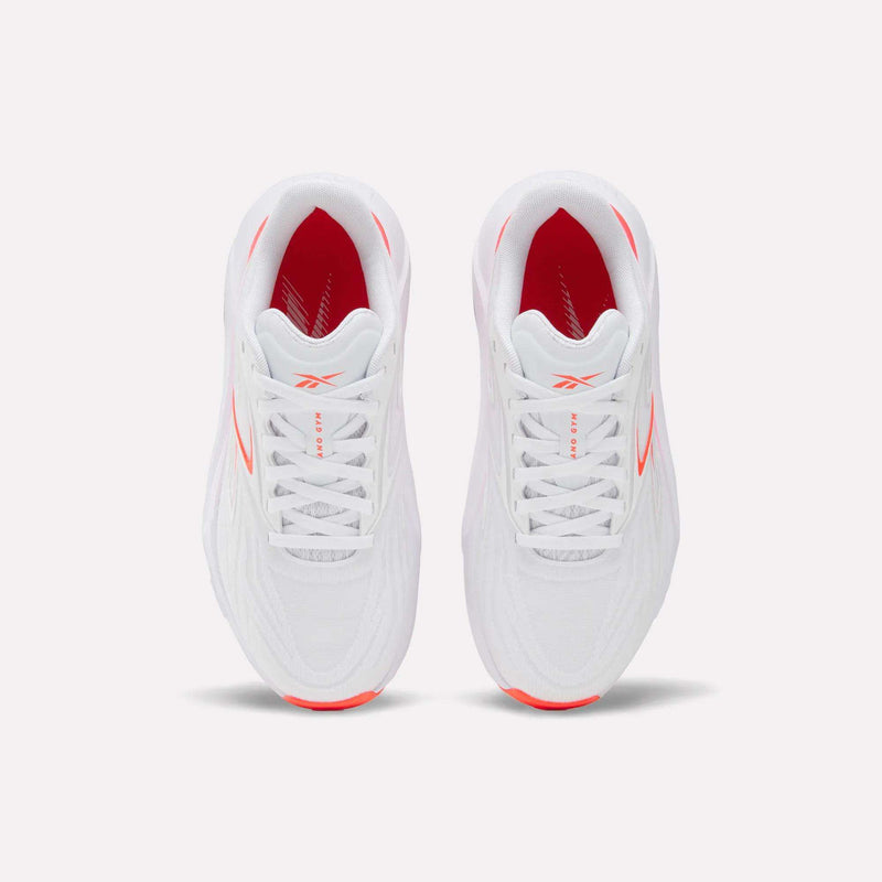 Top view of Women's Nano Gym 2.0 Reebok training shoes in white with red side and interior accents, white laces, and a subtle Reebok logo on the tongue.