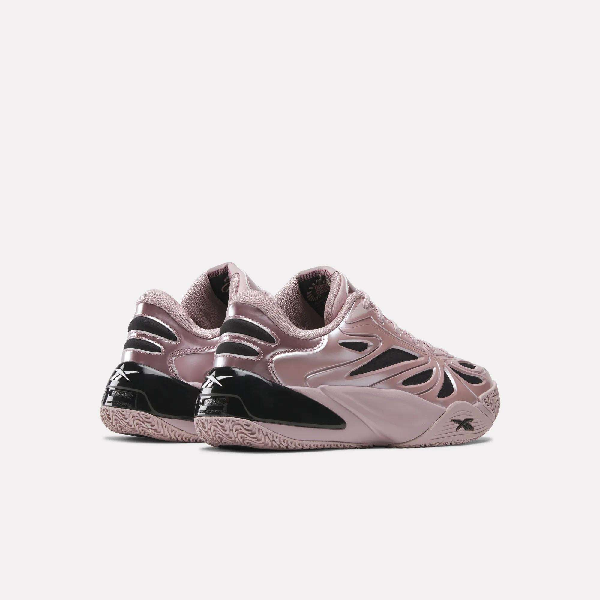The Reebok Angel Reese 1 Basketball Shoes in mauve and black with a glossy, futuristic design are shown on a white background, highlighting the Energy Return System for enhanced basketball performance. Rear and side views of both shoes are displayed.