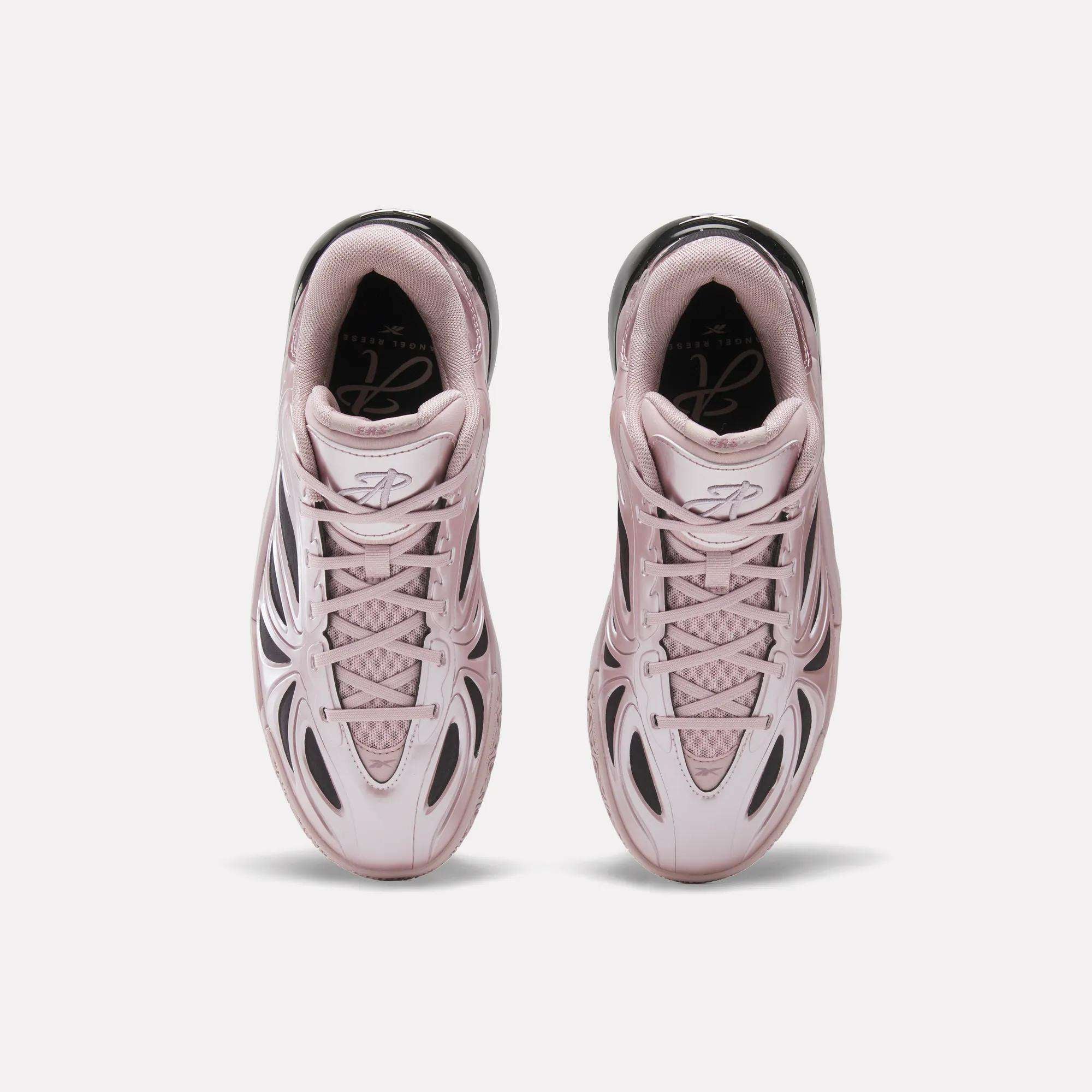 Top view of the Angel Reese 1 Basketball Shoes by Reebok in light pink with black accents, mesh and synthetic upper, and innovative Energy Return System, displayed side by side on a plain white background.