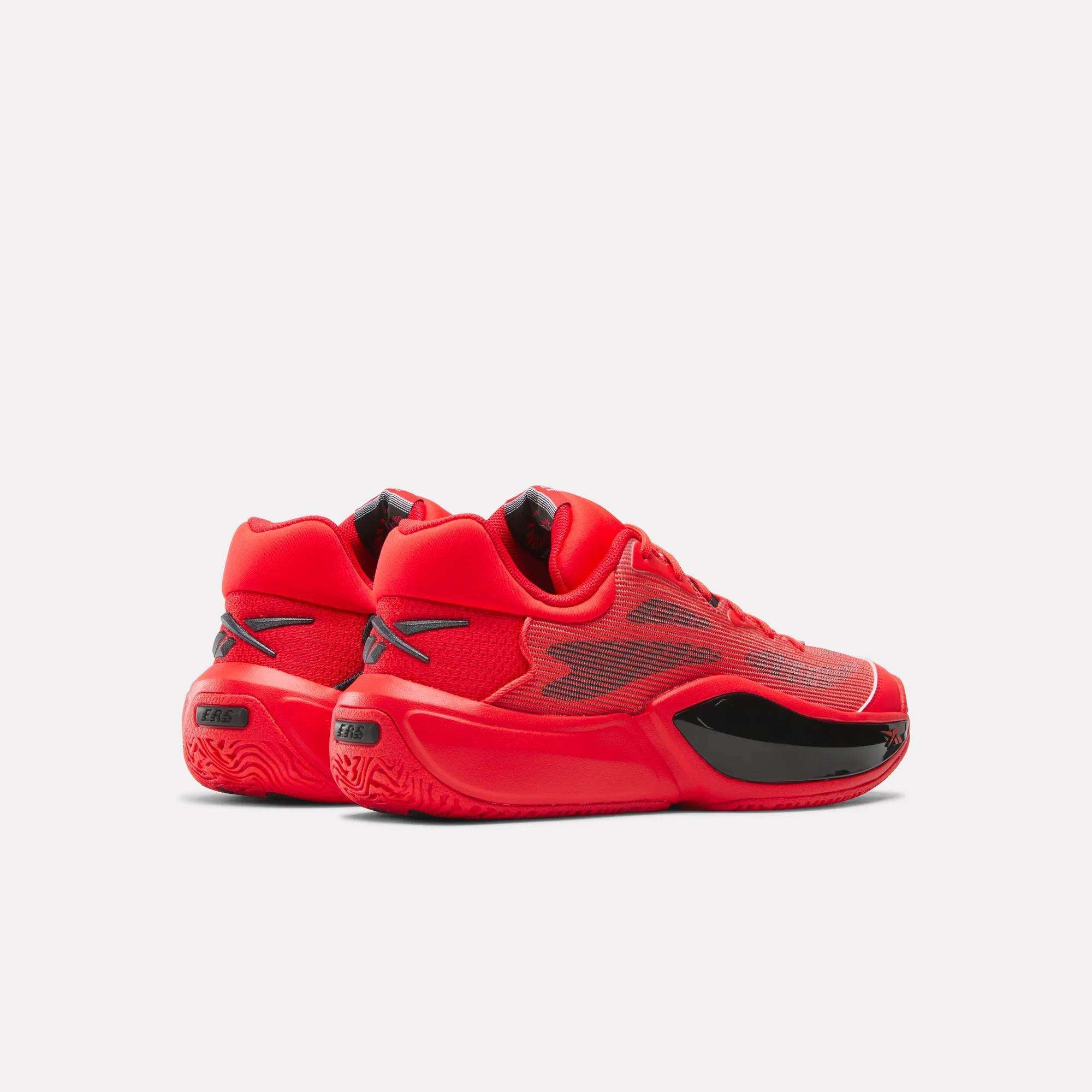 The Reebok Engine A 26 Basketball Shoes feature a bold red color with black accents, a sleek modern profile viewed from the side and back, and textured soles designed for enhanced stability on the court.