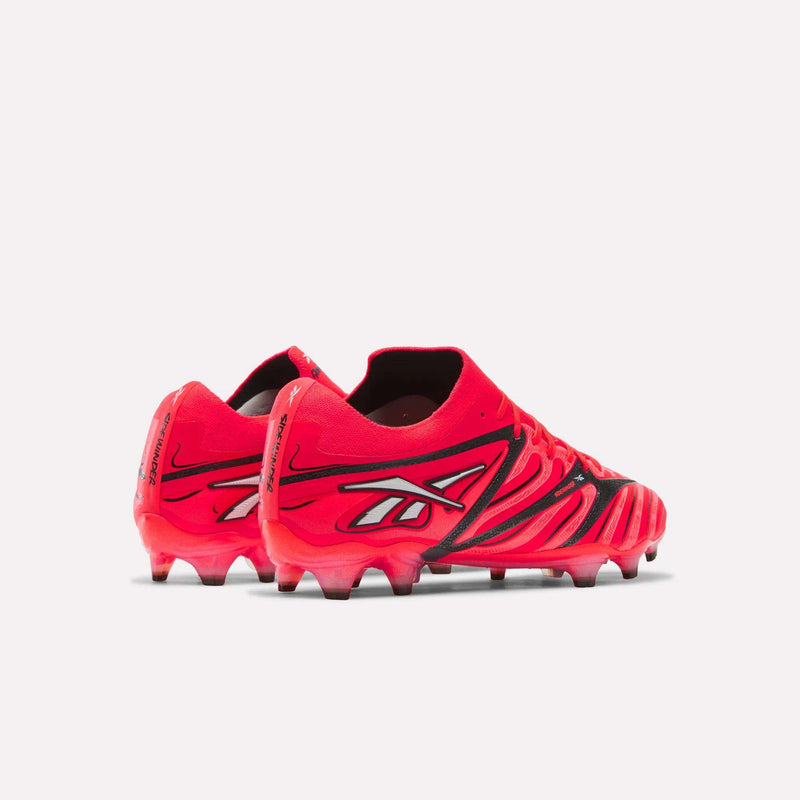 A pair of Reebok Sidewinder 26 Elite Firm Ground Cleats in bold red with black and white accents, engineered for superior ball control on firm grass surfaces, displayed from the back and side perspectives against a plain white background.