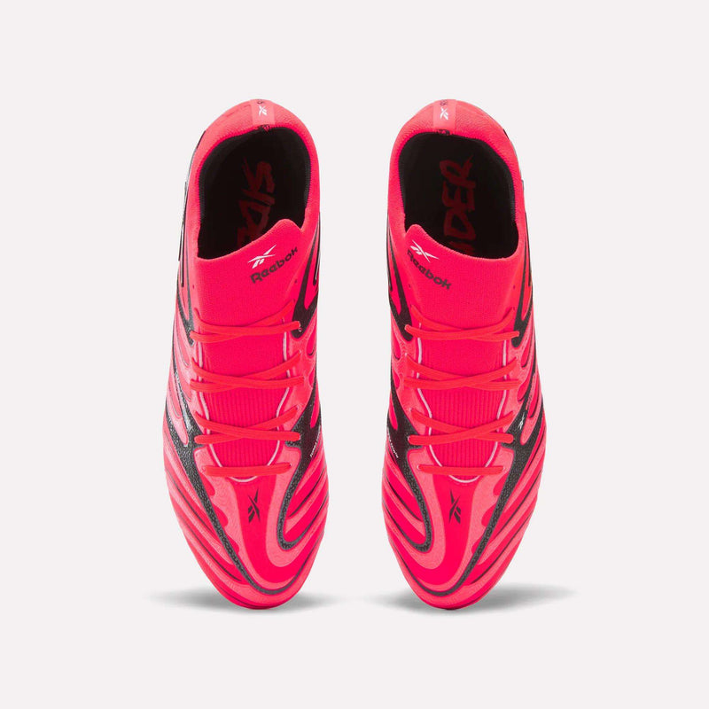 Top view of a pair of vibrant pink and black striped Reebok Sidewinder 26 Elite Firm Ground Cleats, featuring visible Reebok and SIDER text inside, expertly designed for firm grass surfaces to enhance ball control.