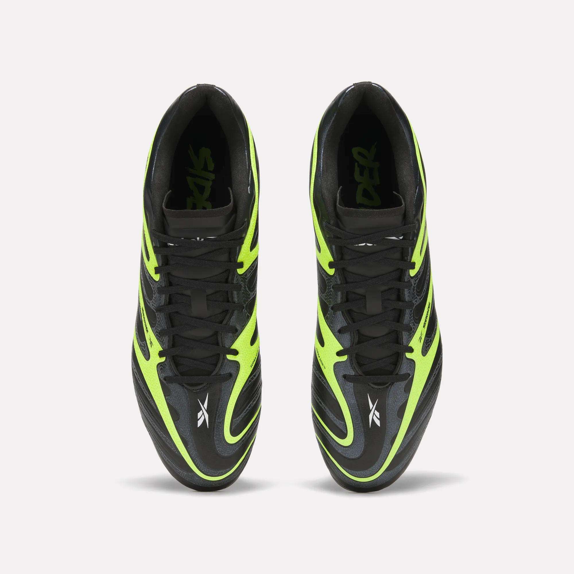 Top view of Reebok Sidewinder 26 League Firm Ground Soccer Cleats in black and neon green with black laces, Reebok logo near the toes, and firm ground studs, shown side by side on a plain white background.
