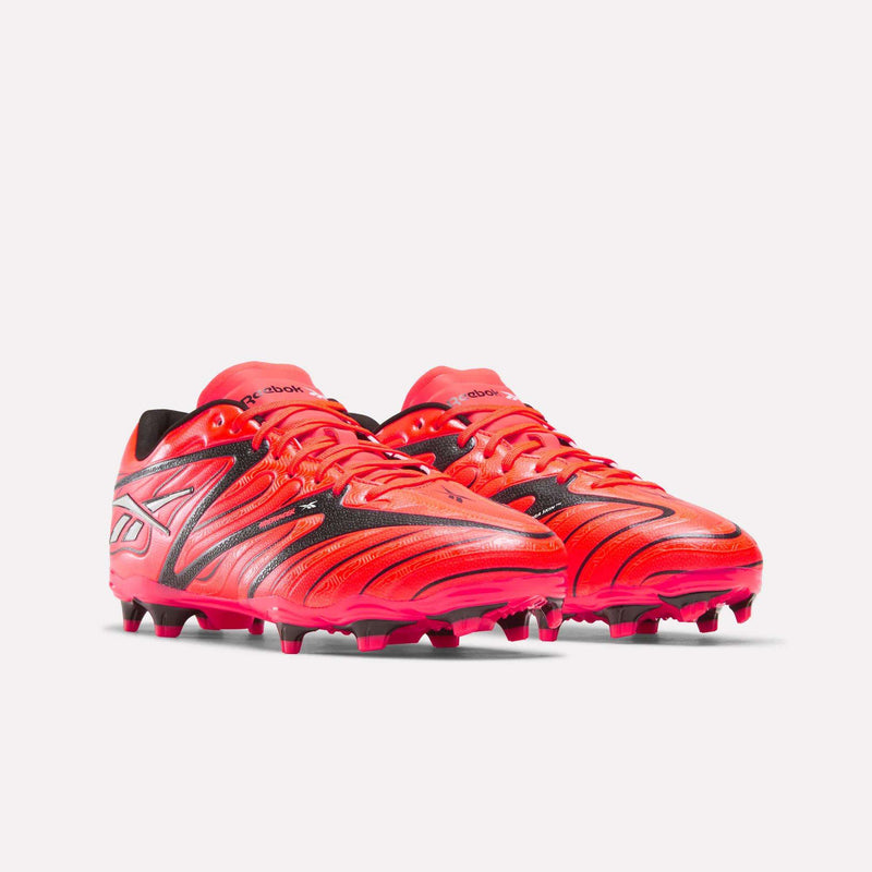 A pair of Reebok Sidewinder 26 League Firm Ground Cleats in bright red with black and silver accents, showcasing the Reebok logo on the side and equipped with firm ground studs for enhanced ball control, displayed on a white background.