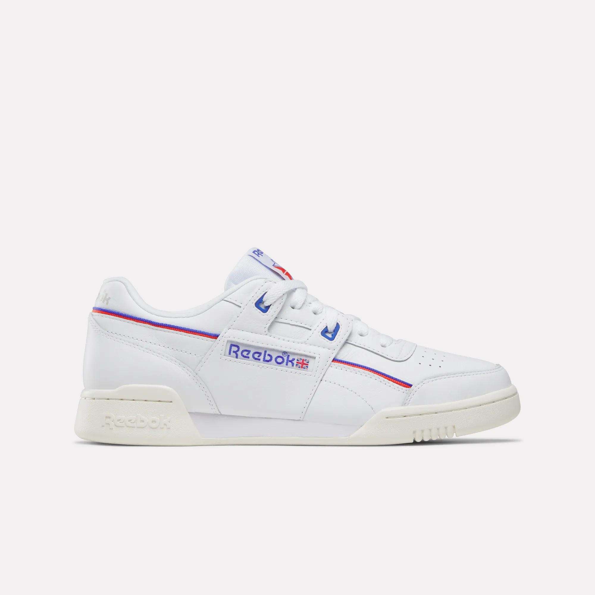 The Women's Club C 85 Shoes by Reebok feature white leather, an off-white sole, blue and red accents, and the iconic Reebok logo with a Union Jack on the side. Shown in a side view against a plain light background.