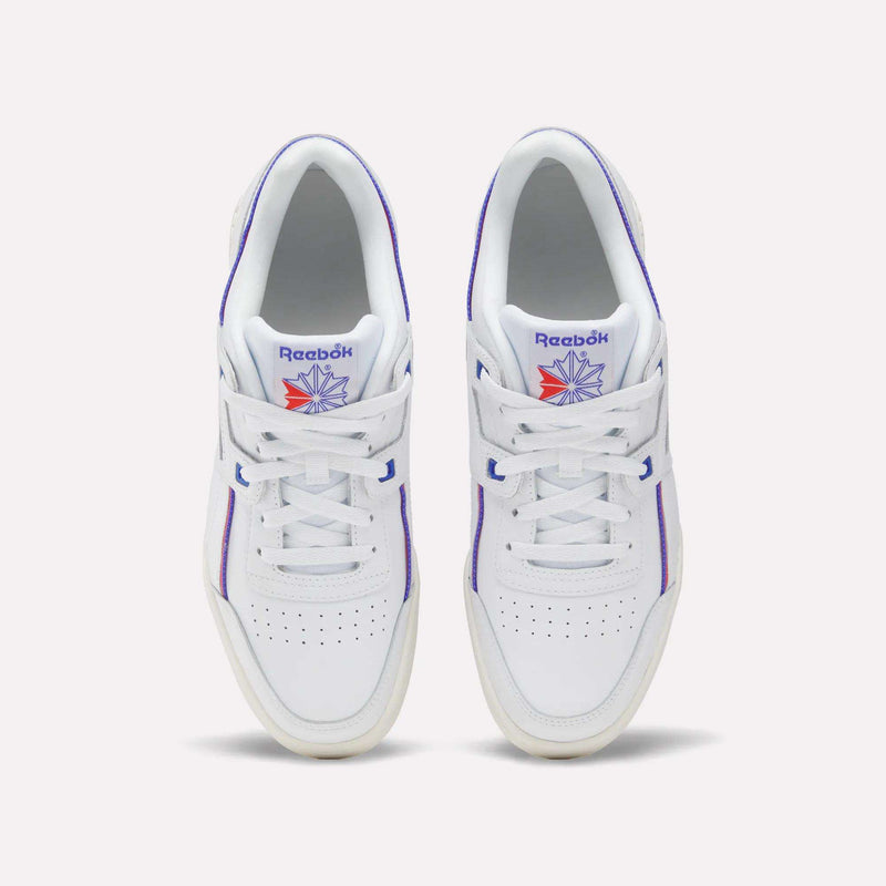 A pair of Women's Club C 85 Shoes by Reebok in white leather with purple accents and a blue and orange Reebok logo on the tongue, shown from above on a light background—classic women's sneakers with timeless style.