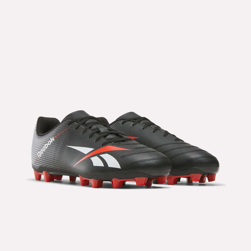 A pair of Reebok Strike Multi Ground Soccer Cleats featuring a black synthetic upper with white and red accents, complemented by red studs on the soles, displayed on a plain white background.
